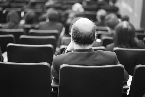 Thinking too much can cause baldness even in a serious meeting room. Stock Photos