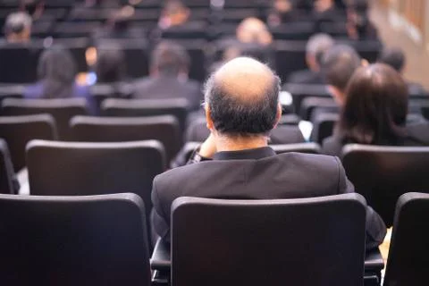 Thinking too much can cause baldness even in a serious meeting room. Stock Photos