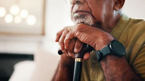 Thinking, walking stick and hands of senior man in home with nostalgia, memory Stock Photos