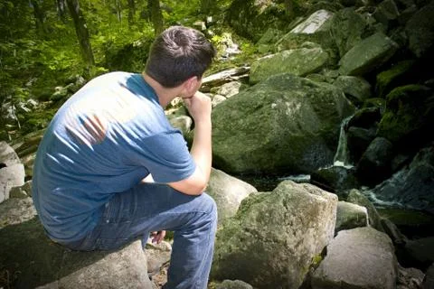 Thinking by the Waterfall Stock Photos