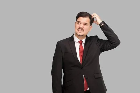 Thinking well dressed man, looking up and pondering Foto stock