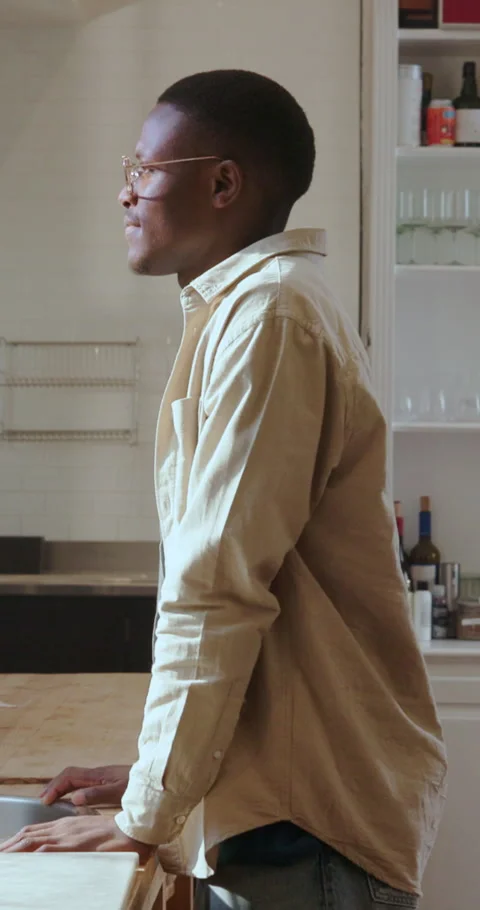 Thinking, window and black man in kitchen, smile and contemplation for memory Stock Footage 334313117