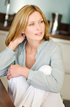 Thinking woman, sitting in kitchen Stock Photos