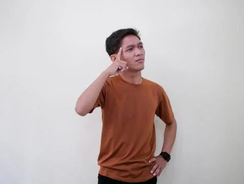 Thinking Young Man Looking Up Against White Wall Stock Photos