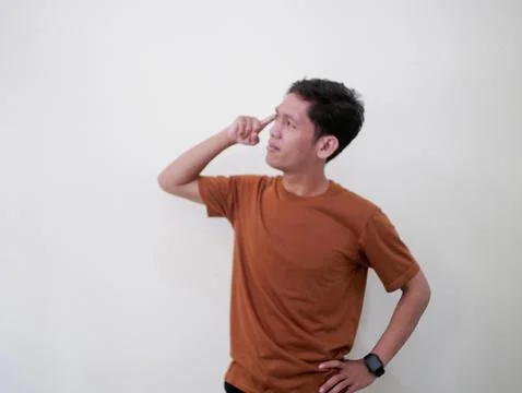 Thinking Young Man Looking Up Against White Wall Stock Photos