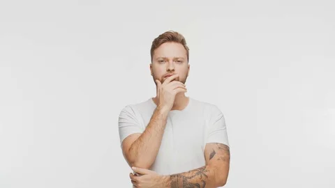 Thinking young man over vibrant background. Studio portrait of expressive Stock Footage 123778670