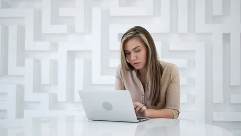 Thinking young woman using laptop Stock Footage 102969712