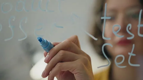 Thinks Business Analyst draws a diagram of a business plan on a transparent Stock Footage 242540033
