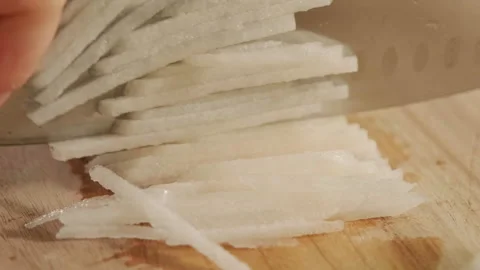 Thinly slice the pear, which serves as a garnish for food. Stock Footage 247231866