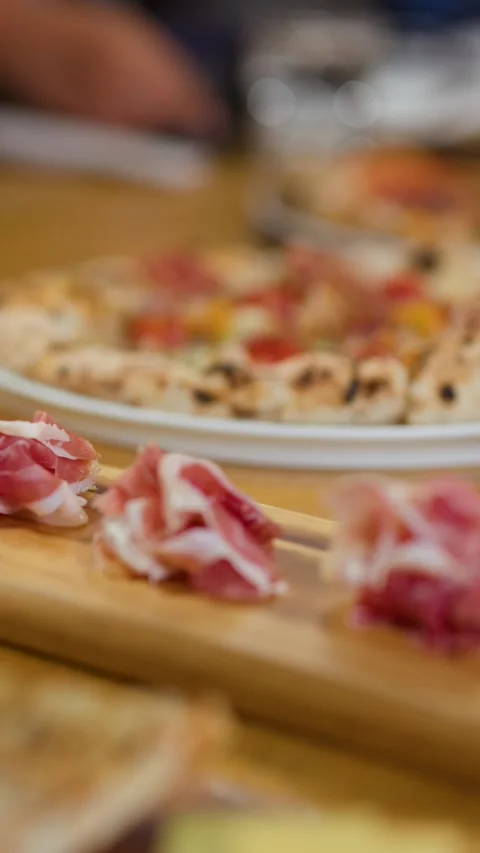 Thinly Sliced Cured Ham on Wooden Board with Pizza Background Stock Footage 337767519