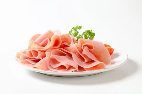 Thinly sliced ham on plate Stock Photos