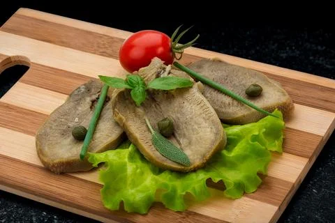 Thinly sliced meat appetizer with capers and garnish Stock Photos