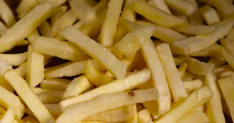 Thinly sliced potatoes for baking in oil, frozen potatoes for deep-frying Stock Footage 272572644