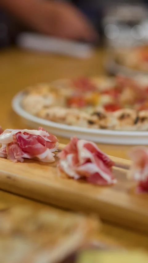 Thinly Sliced Prosciutto Ham Served on a Wooden Charcuterie Board Stock Footage 337860414