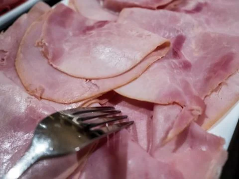 Thinly sliced shaved Ham meat on a serving plate Stock Photos