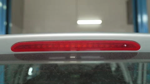 A third brake light is integrated into a car spoiler. Stock Footage 341334620