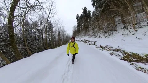 Third Person View walking through snowy forest in Switzerland on snow path. Stock Footage 148498596