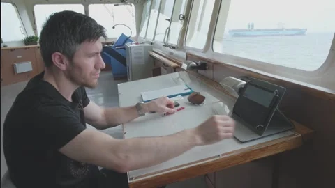 Third tanker navigator sits in professional wheelhouse 動画素材 133037523