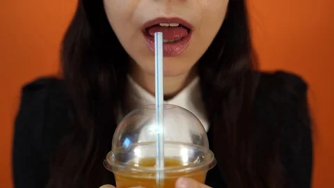 Sip of freshness. Drinking straw in mouth. Sipping drink through straw.  Female lips while drinking with