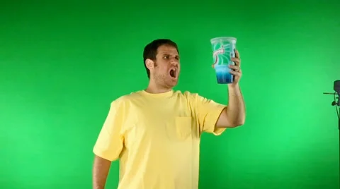 Thirsty man drinks messy blue liquid green screen Stock Footage 49360332
