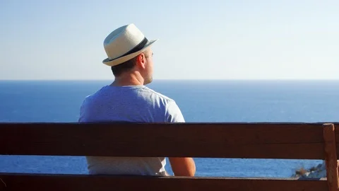 Thirsty man relax on bench at edge of cliff drink water from plastic bottle Video stock 107097782