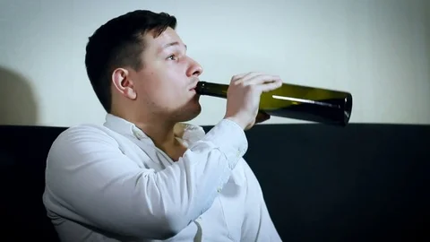 Thirsty Tired Chubby Man Sitting on the Couch, Having Beer, Drinking Slow From Stock Footage 71556855