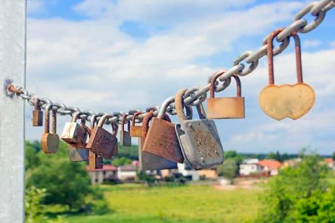 Thirteen rusty locks on a thick galvanized chain Stock Photos