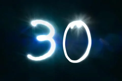 Thirty Numbers written with a flashlight during long exposure Stock Photos