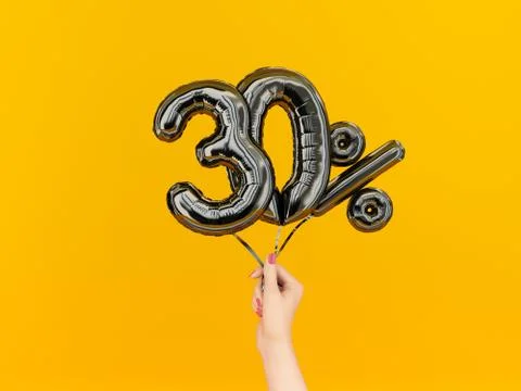 Thirty percent symbol discount. 30 % sale banner black flying foil balloons o Stock Illustration