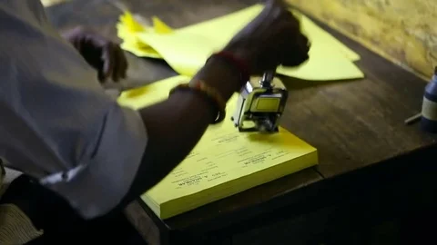 Thiruvanomalai, India  DEC, 2016: The Indian man stamping the forms. Video stock 77791239