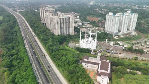 At Thohir Mosque next to the toll road Stock Footage 286093559