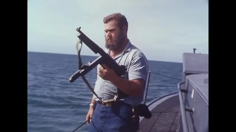 AN THOI - 1965 - USCGC Point Grey's Gunner's Mate 1st Class MJ Kelleher holds a Stock Footage 341862704