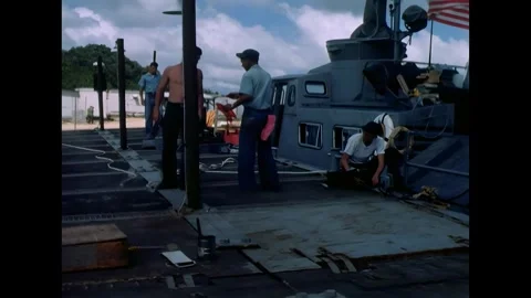 AN THOI - 1966 - A man gets up after working on a signal light, and another puts Stock Footage 341862688
