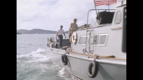 AN THOI - 1966 - Men sail swift boats away from the causeway at An Thoi Naval Stock Footage 341862672