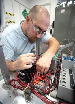 Thomas Cauvel, an intern assisting with software/electrical engineering on... 写真素材