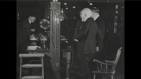 Thomas Edison re-enacts the invention of the lightbulb. Stock Footage 100995938