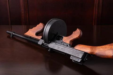 Thompson submachine gun on a dark table vintage style background photography Stock Photos