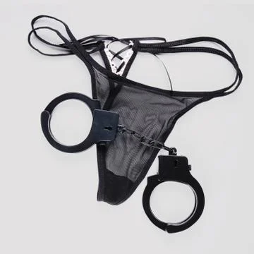 Thong and handcuffs Stock Photos