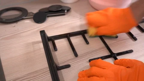 Thorough Cleaning of a Kitchen Rack: Effortlessly Removing Dirt with a Sponge Stock Footage 321050860