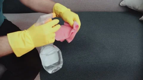 Thorough cleaning of the sofa with a rag and a cleaning agent. Video stock 148569517