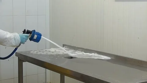 Thorough Cleaning of a Stainless Steel Table With Spray in the Morning Stock Footage 320796812