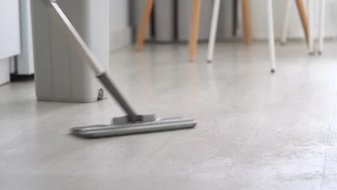 Thorough floor cleaning with a mop. Wet wooden white floor. Wipe the floor with  Stock Footage 312574423