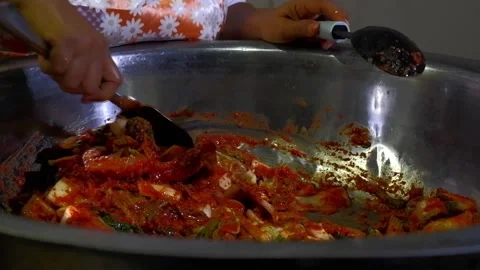 Thorough stir mixing of chili paste in napa cabbage on mixing basin in making Stock Footage 172427975