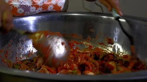 Thorough stir mixing of chili paste in napa cabbage on mixing basin in making Stock Footage 172427977