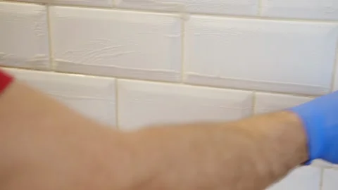 Thoroughly cleaning the grout between tiles Stock-Footage 333676350