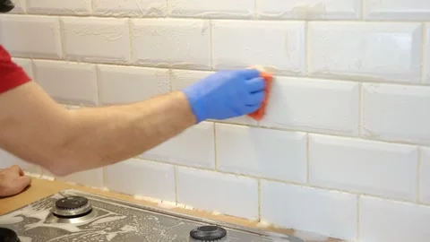 Thoroughly cleaning the grout between tiles Stock Footage 335446689