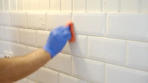 Thoroughly cleaning the grout between tiles Stock Footage 336065181