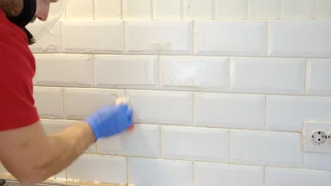 Thoroughly cleaning the grout between tiles Stock Footage 336728282