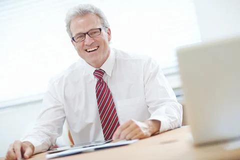 Thoroughly enjoying business. Mature, attractive male business associate Stock Photos