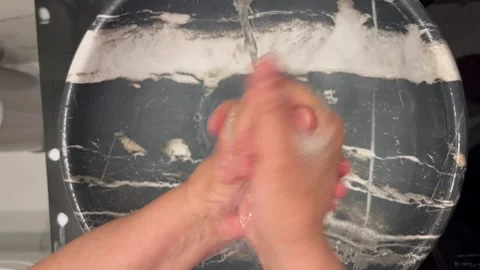Thoroughly Washing Hands with Soap in a Marble Basin Video stock 345741154